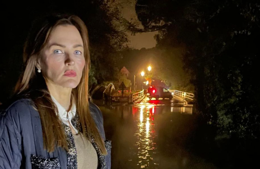 Marisa is standing in flooded water in Leigh. She looks very concerned, because the flood water is very dirty and ankle height.