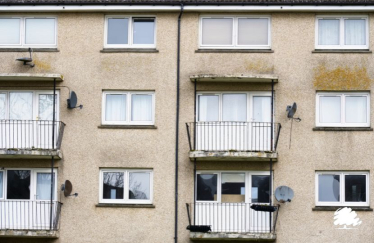 A stock photo of a very dreary and run down social housing block. Looks very much like a social housing block described in our article.